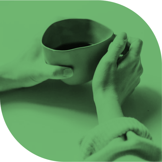 A hand holding a cup of coffee